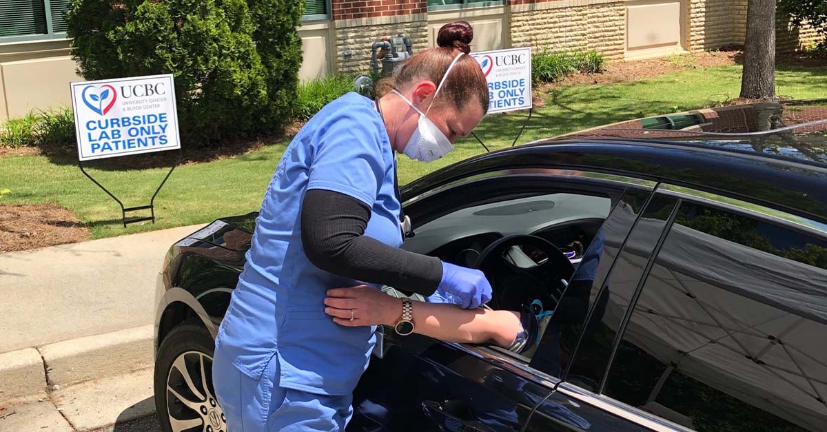 UCBC Nurse doing blood draw from a patient curbside.