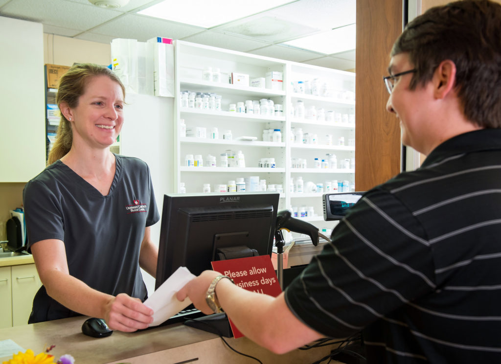 A pharmacist assisting a customer.