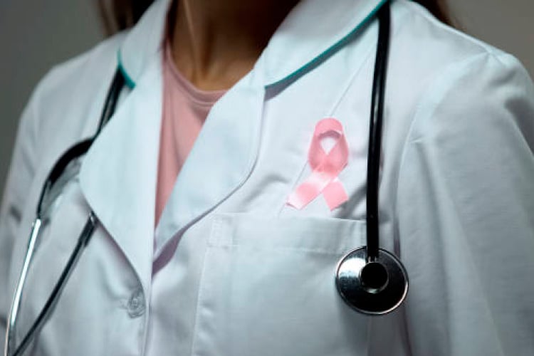 Doctor with breast cancer awareness ribbon