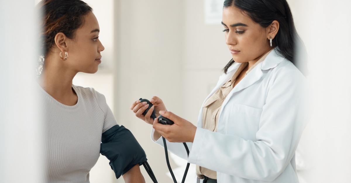 Doctor checking patient's blood pressure