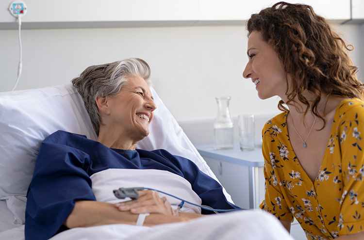Smiling patient in the hospital, chatting with loved one.