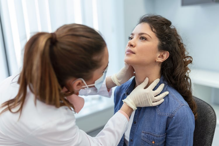 Doctor checking tonsils