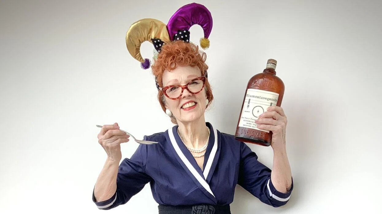 Karen Strelecki dressed as Lucille Ball holding a bottle of "Vitameatavegamin"